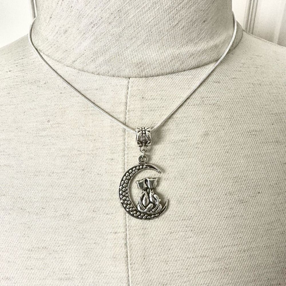Silver tone cats sitting on moon pendant necklace